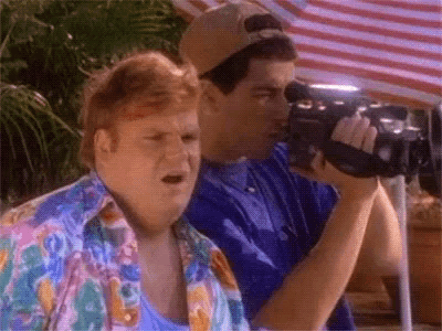 Two Men Are Standing Next To Each Other And One Is Holding A Video Camera GIF