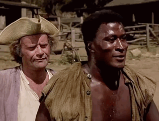 Two Men Are Standing Next To Each Other And One Is Wearing A Cowboy Hat GIF
