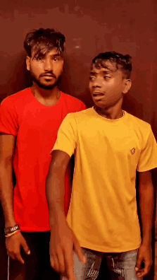 Two Men Are Standing Next To Each Other And One Is Wearing A Yellow Shirt GIF