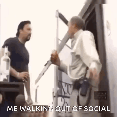 Two Men Are Standing Next To Each Other And One Of Them Is Holding A Bottle Of Vodka . GIF
