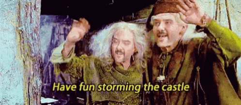 Two Men Are Standing Next To Each Other And One Of Them Is Holding A Sword . GIF