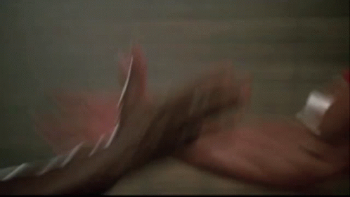 Two Men Are Standing Next To Each Other And One Of Them Is Holding The Other 'S Hand . GIF