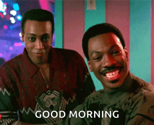 Two Men Are Standing Next To Each Other And One Of Them Is Smiling And The Other Is Saying Good Morning GIF