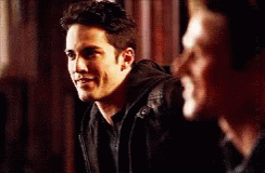 two men are standing next to each other and one of them is wearing a black jacket