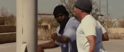 Two Men Are Standing Next To Each Other And One Of Them Is Wearing A Black Mask . GIF
