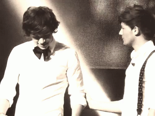 Two Men Are Standing Next To Each Other And One Of Them Is Wearing A Bow Tie GIF