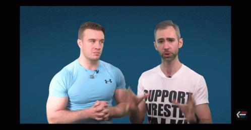 Two Men Are Standing Next To Each Other And One Of Them Is Wearing A Shirt That Says Support Wrestling GIF