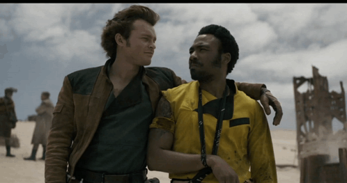 Two Men Are Standing Next To Each Other And One Of Them Is Wearing A Yellow Shirt That Says ' A ' On It GIF