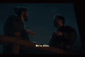 two men are standing next to each other and one of them says we 're allies