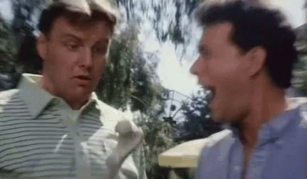 Two Men Are Standing Next To Each Other And Talking . GIF