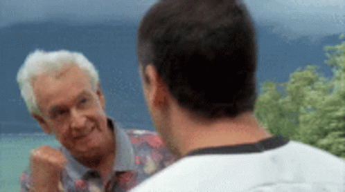 Two Men Are Standing Next To Each Other And Talking To Each Other . GIF