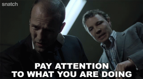 Two Men Are Standing Next To Each Other And The Words Pay Attention To What You Are Doing GIF