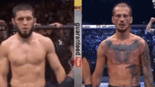 Two Men Are Standing Next To Each Other In A Boxing Ring Holding Hands . GIF