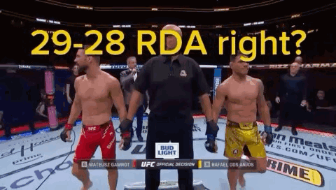 Two Men Are Standing Next To Each Other In A Boxing Ring With The Words 29-28 Rda Right Written Above Them GIF