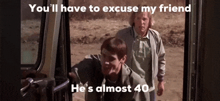 Two Men Are Standing Next To Each Other In A Car Doorway . GIF