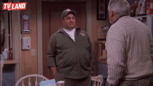 Two Men Are Standing Next To Each Other In A Kitchen . GIF