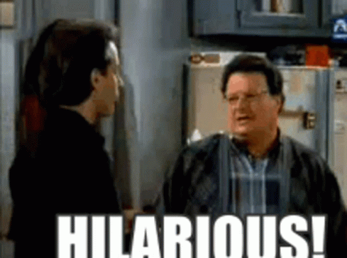Two Men Are Standing Next To Each Other In A Kitchen With The Words Hilarious Written On The Bottom . GIF