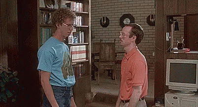 Two Men Are Standing Next To Each Other In A Living Room With A Computer In The Background . GIF
