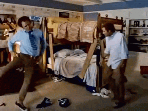Two Men Are Standing Next To Each Other In A Messy Room With A Bunk Bed . GIF