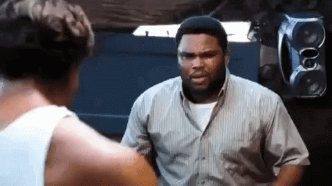 Two Men Are Standing Next To Each Other In A Room . GIF