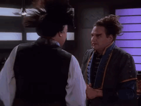 Two Men Are Standing Next To Each Other In A Room And One Of Them Is Talking To The Other . GIF