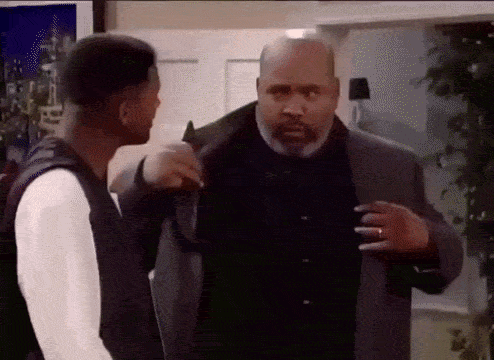 Two Men Are Standing Next To Each Other In A Room And Talking To Each Other . GIF