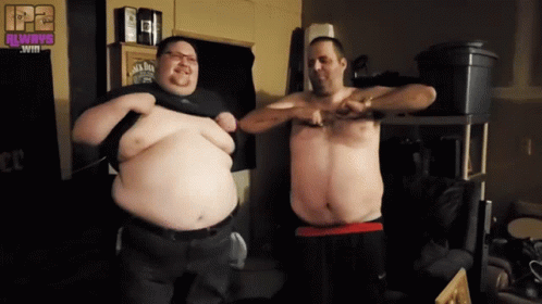 Two Men Are Standing Next To Each Other In A Room With A Jack Daniels Sign On The Wall GIF