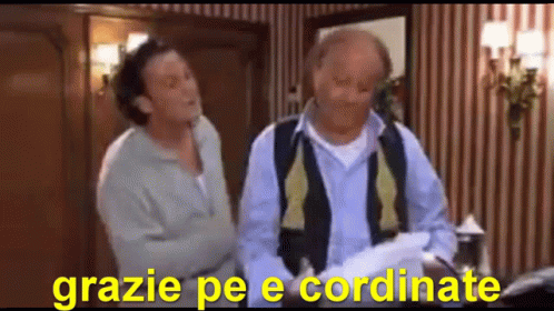 Two Men Are Standing Next To Each Other In A Room With The Words Grazie Pe E Coordinate In The Corner GIF