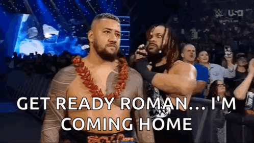 Two Men Are Standing Next To Each Other In A Wrestling Ring And One Of Them Is Talking To The Other . GIF