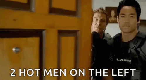 Two Men Are Standing Next To Each Other In Front Of A Door . GIF