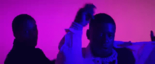 Two Men Are Standing Next To Each Other In Front Of A Purple And Pink Background . GIF