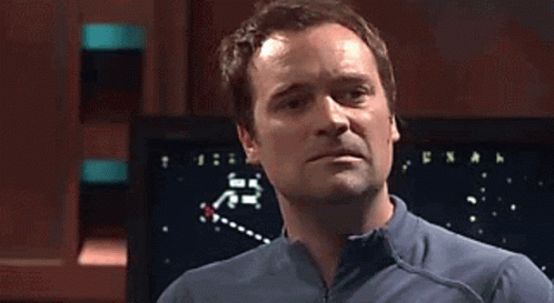 Two Men Standing Next To Screen Pointing GIF