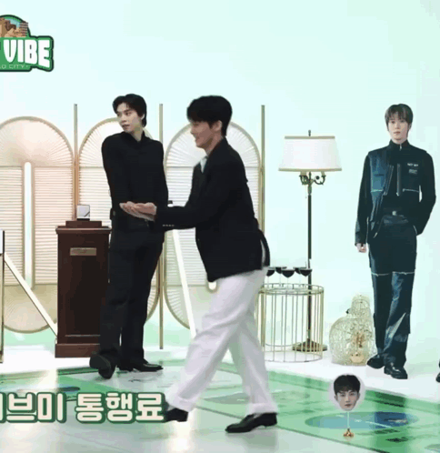 Two Men Are Standing Next To Each Other In Front Of A Sign That Says Vibe On It GIF