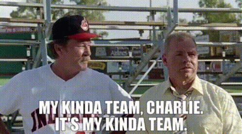 Two Men Are Standing Next To Each Other On A Baseball Field . One Of The Men Is Wearing A Baseball Uniform . GIF