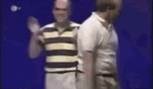 Two Men Are Standing Next To Each Other On A Blue Background . GIF