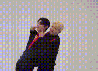 Two Men Are Standing Next To Each Other On A White Background And Holding Hands . GIF