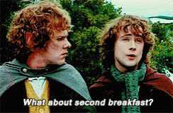 Two Men Are Standing Next To Each Other Talking About Second Breakfast GIF