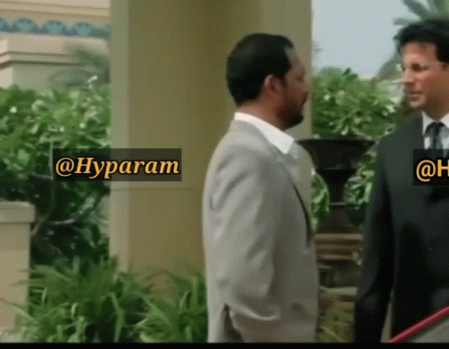Two Men Are Standing Next To Each Other With A Sign That Says @Hyparam GIF
