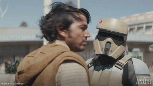 Two Men Standing Next To Star Wars Logo GIF