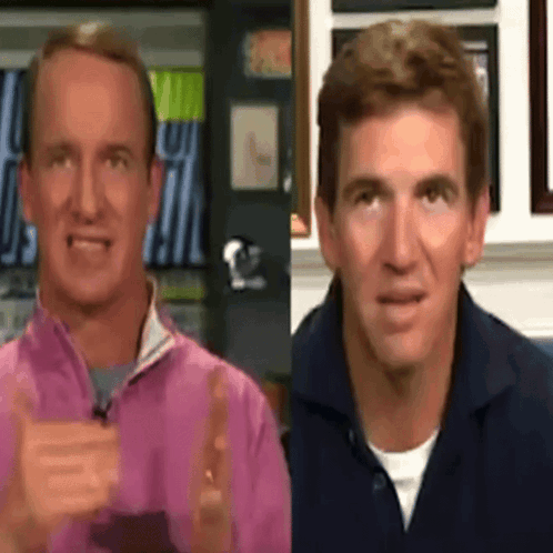 two men are standing next to each other with one wearing a pink jacket