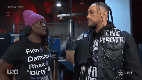 Two Men Are Standing Next To Each Other With One Wearing A Shirt That Says Finn And Damian GIF