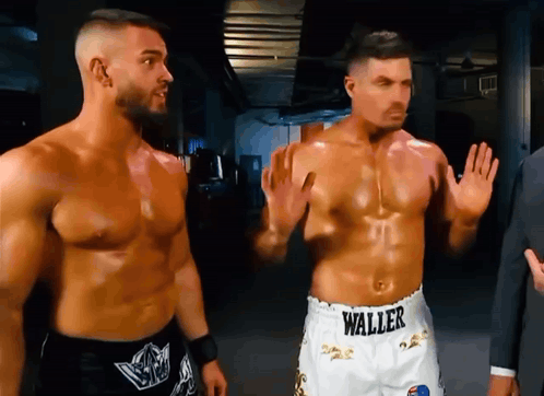 two men are standing next to each other with one wearing shorts that say waller on them