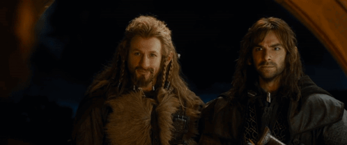 Two Men Are Standing Next To Each Other With The Words At Your Service Written On The Bottom GIF