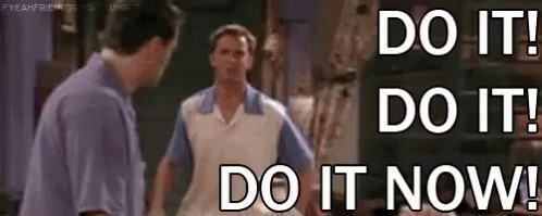 Two Men Are Standing Next To Each Other With The Words `` Do It ! Do It ! Do It Now ! '' . GIF