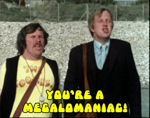 Two Men Are Standing Next To Each Other With The Words " You 'Re A Megalomaniac " On The Bottom GIF