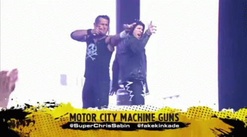 Two Men Are Standing Next To Each Other With Their Arms Outstretched And The Words Motor City Machine Guns Above Them . GIF