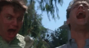 Two Men Are Standing Next To Each Other With Their Mouths Open And One Is Screaming . GIF