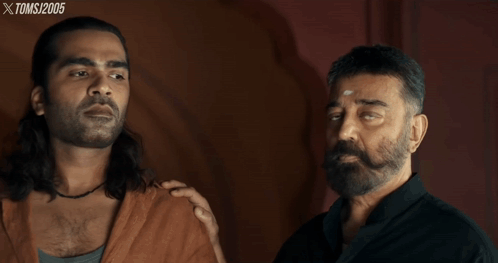 Two Men Are Standing Next To Each Other With Xtoms 2005 Written On The Bottom Right GIF