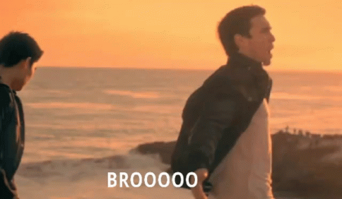 Two Men Are Standing On A Beach With The Words Brooooo Written On The Bottom GIF
