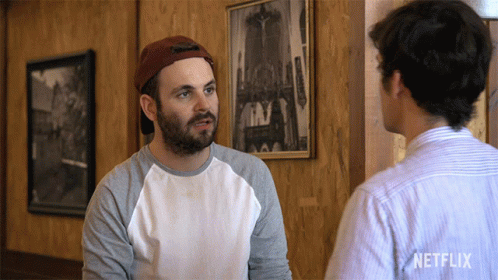Two Men Talking In Room With Netflix Logo GIF